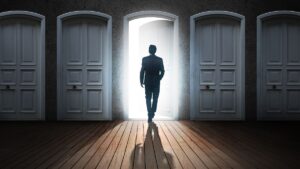 Hombre frente a puerta abierta entre cerradas
