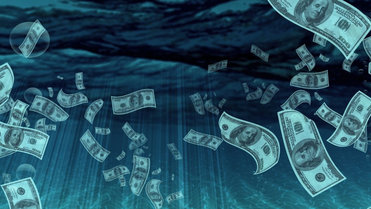 Billetes dólares flotando en agua azul ondulada