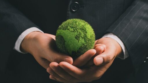 Empresario sosteniendo esfera verde moss